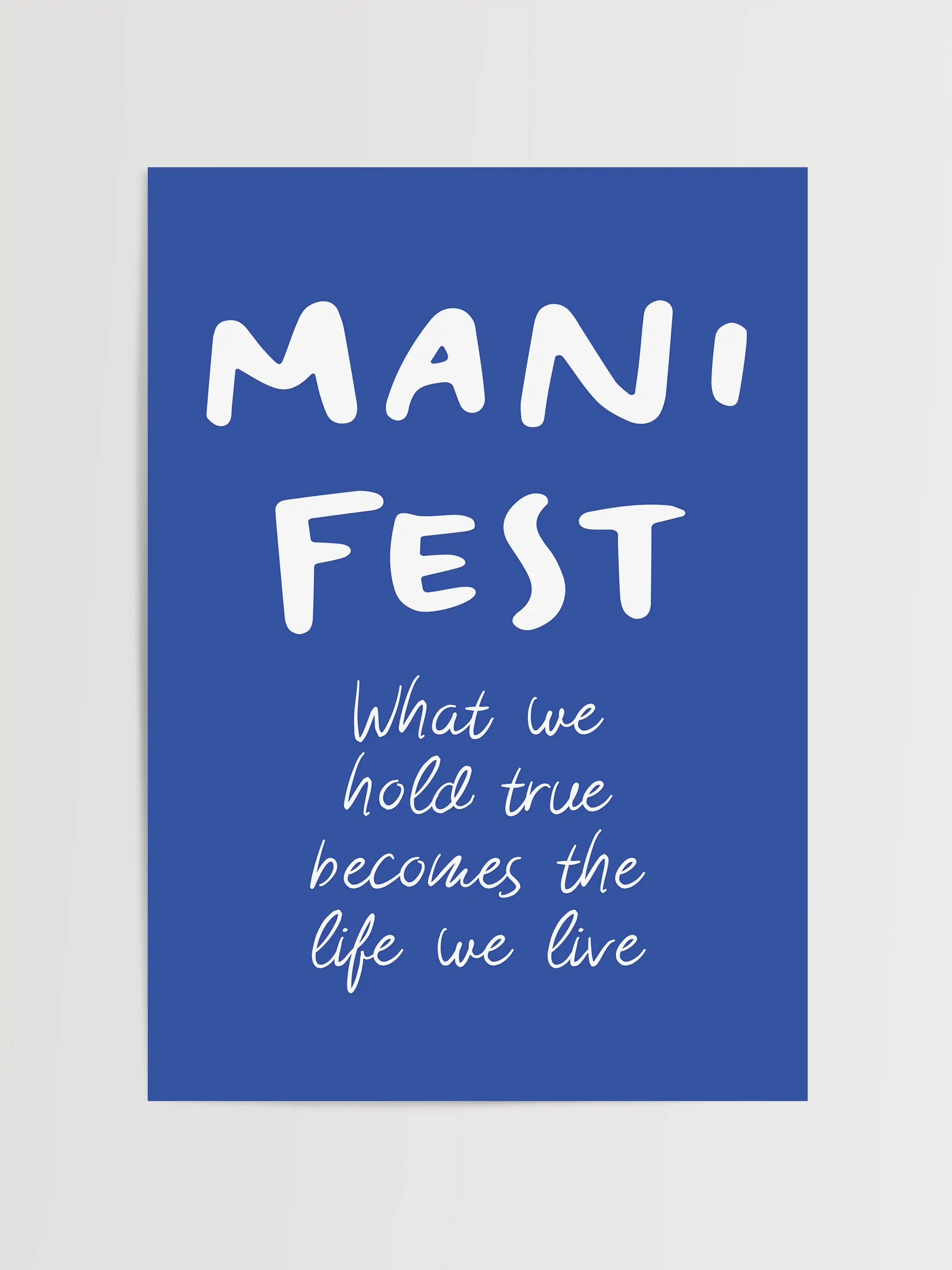 Framed blue poster with handwritten-style typography and a manifestation quote.